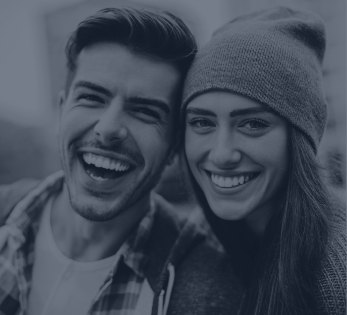 Smiling young man and woman taking selfie together