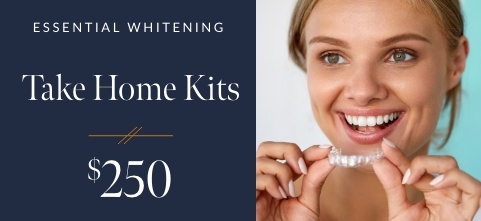 Smiling woman holding teeth whitening tray