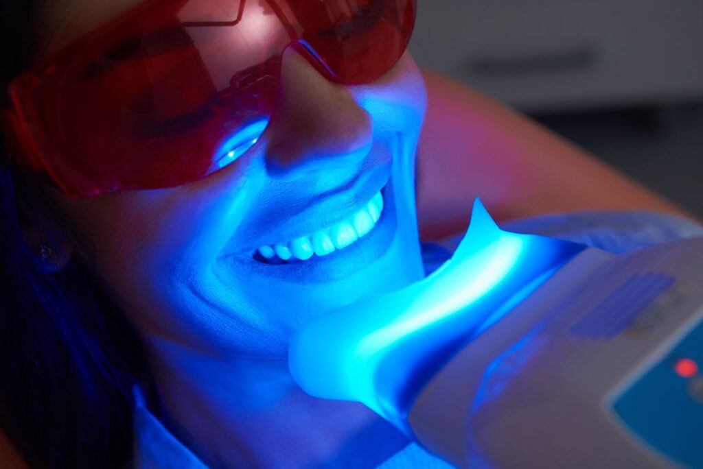 A woman getting a professional teeth whitening treatment.