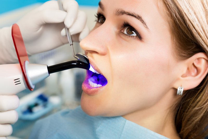 A woman receiving dental fillings from her dentist